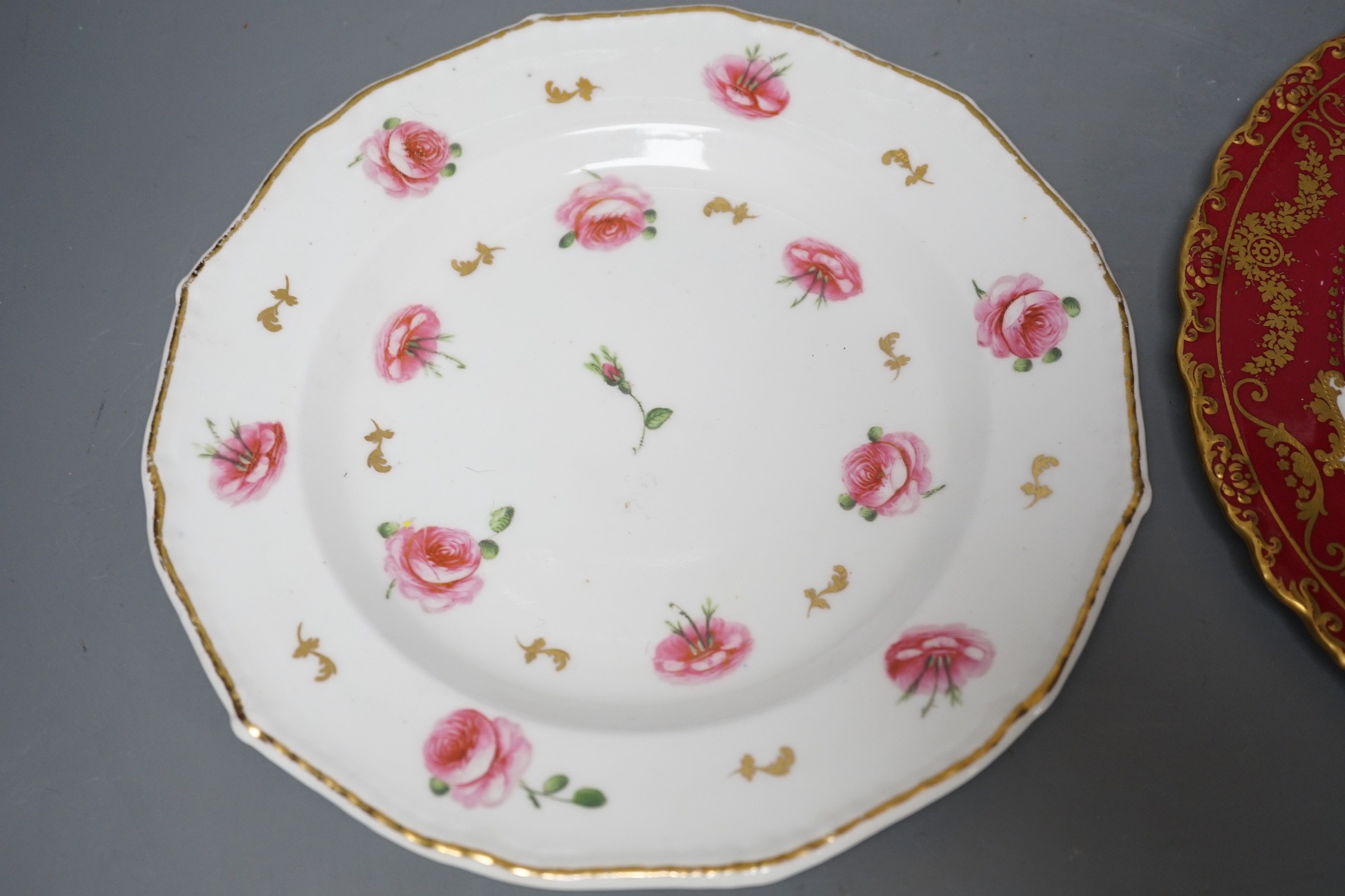 A Royal Crown Derby plate painted with fruit under claret ground by Cuthbert Gresley, signed, Made for Osler London, and a Derby King Street plate with roses